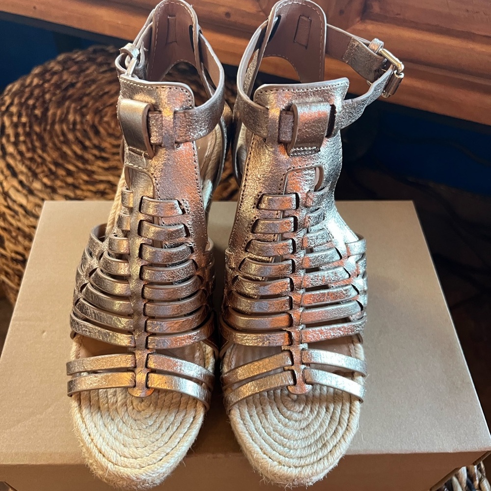 Signature espadrille wedge by Vince Camuto. They are a bronze color .